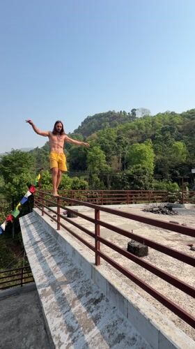 Man performs handstand on railing in Pokhara, Nepal