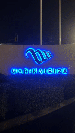 Rainy night at Marina Ibiza: superyachts and luxury boutiques