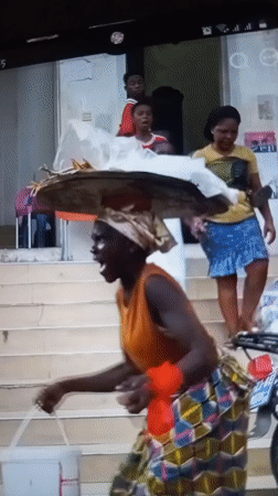 Balancing a basket overhead while descending outdoor stairs