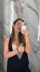 Woman takes selfie against marble wall in Moscow