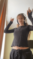 Young woman poses and dances indoors in Ufa