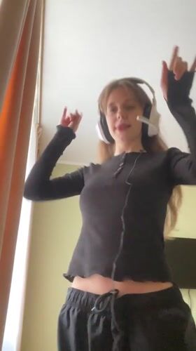 Young woman poses and dances indoors in Ufa
