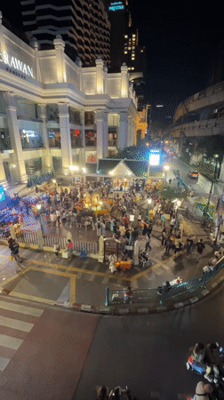 Crowds gather at Bangkok shrine and luxury store