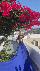 Blue dress, blue domes, and caldera views in Santorini