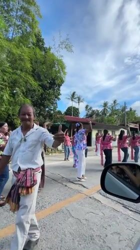Colorful sash and smiles at a Ban Tai gathering