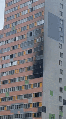 Fire damage visible on apartment building facade in Murino