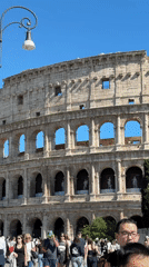 Street performer beatboxes near Rome's Colosseum on sunny afternoon