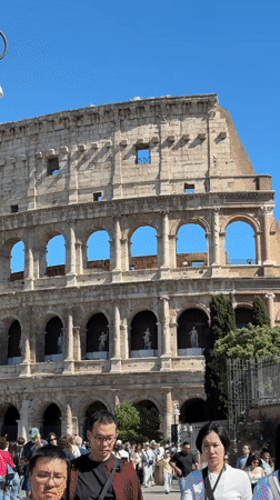 Street performer beatboxes near Rome's Colosseum on sunny afternoon