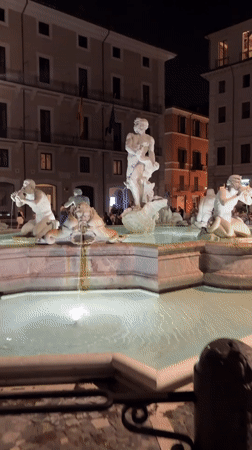 Bernini's Fountain of Four Rivers lit up at night, Piazza Navona