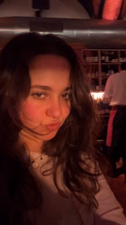 Young women dine at red-lit Milan restaurant Friday evening