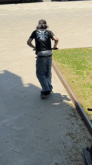 Young men ride scooters on sidewalk in l'Hospitalet de Llobregat