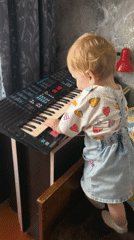 Hands big and small explore a Yamaha keyboard in Sterlitamak