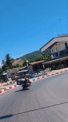 Motorcycles and temple gates: a quiet morning in Nathon