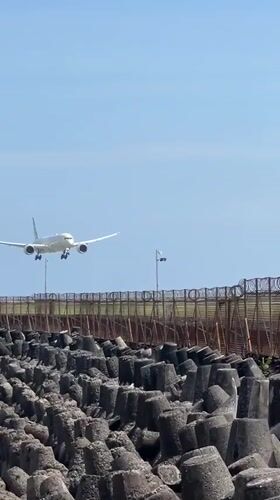 Early morning beach activity captured near Kuta breakwater infrastructure