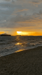 Ocean sunset with waves and distant ships in Pattaya