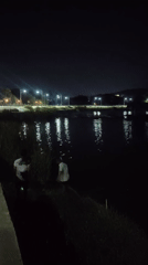 Two people active near water at night in Thailand