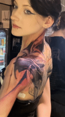 Woman shows off elaborate back tattoo in Moscow mirror