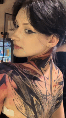 Woman shows off elaborate back tattoo in Moscow mirror