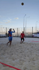 Beach volleyball session on a sand court, mid-afternoon