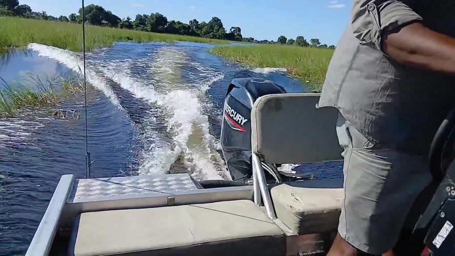 Boat passengers navigate waterways near Gunotsoga, Botswana