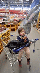 Toddler with balloon spotted shopping in Saint Petersburg supermarket
