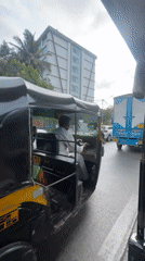 Auto rickshaw passenger documents Mumbai street traffic scene