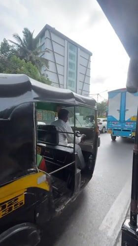 Auto rickshaw passenger documents Mumbai street traffic scene