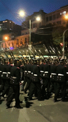 Religious procession with hooded participants moves through La Paz