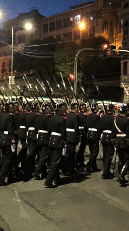 Religious procession with hooded participants moves through La Paz