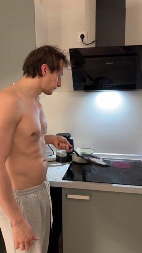 Man cooks dinner in kitchen in Murino, Russia