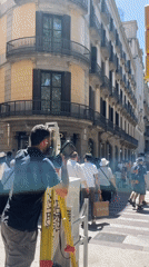 Surveyor conducts street measurements in Barcelona's commercial district