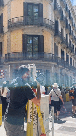Surveyor conducts street measurements in Barcelona's commercial district