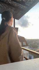 Woman documents sunset evening on Sochi balcony with baby