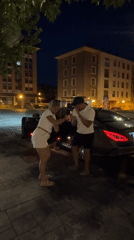 Evening gathering near parked car in Mungia, Spain