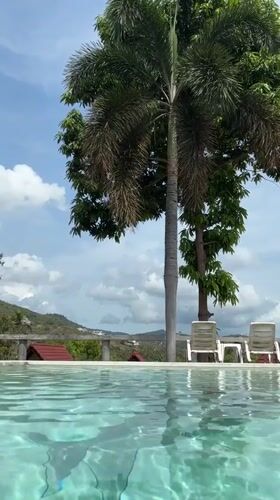 Woman films poolside content in Thailand daytime