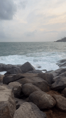 Rough seas crash against rocky Thalaramba coastline under overcast skies