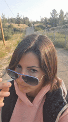 Woman takes selfies on rural road in Lachish, Israel