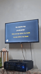 Woman performs karaoke at indoor venue in La Tagua, Venezuela