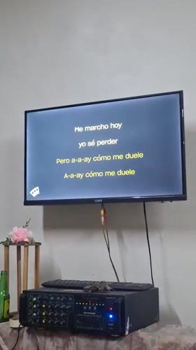 Woman performs karaoke at indoor venue in La Tagua, Venezuela