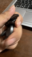 Person demonstrates magnetic toys on wooden table in Multan