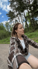 Woman cycles through rural paths near Раздолье, Russia
