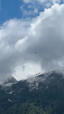 Aircraft spotted over cloudy Krasnaya Polyana mountains