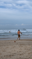 Surfer heads to ocean waves in Kathaluwa, Sri Lanka