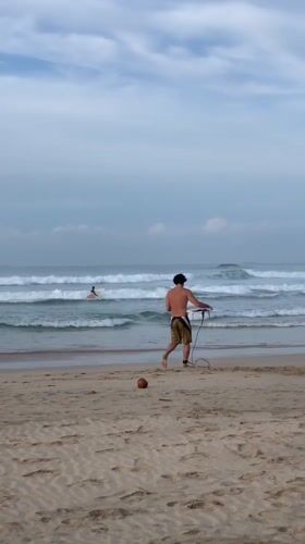 Surfer heads to ocean waves in Kathaluwa, Sri Lanka