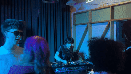 DJ performs at dimly lit venue in Dundee