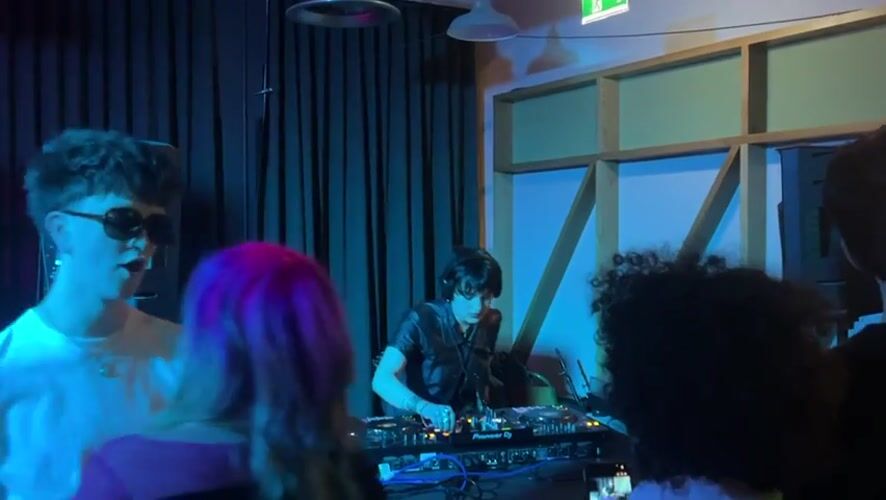 DJ performs at dimly lit venue in Dundee