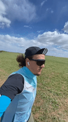 Person walks, runs through Russian fields on cloudy morning