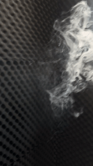 Person works in home studio as white smoke drifts