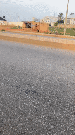 Motorcyclist observed traveling on asphalt road in Bukuru, Nigeria