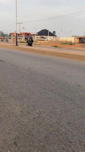 Motorcyclist observed traveling on asphalt road in Bukuru, Nigeria